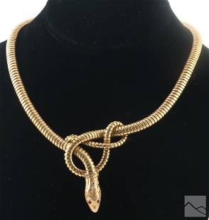 18K Gold Antique Egyptian Tubogas Serpent Necklace: An 18k gold antique ladies Egyptian designer knotted Cleopatra asp snake necklace. A tubogas style link design with a knotted snake at the center. Articulated head set with lab created rubies and acce