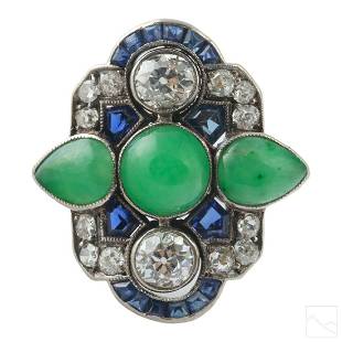 18K Gold Art Deco Diamond Green Jade Sapphire Ring: An exquisite 18k white gold and gemstone Art Deco ring. Features a 6mm wide apple green jade cabochon flanked by apple green tear drop shaped jade cabochons measuring 7mm x 5mm. Surrounding the jade a