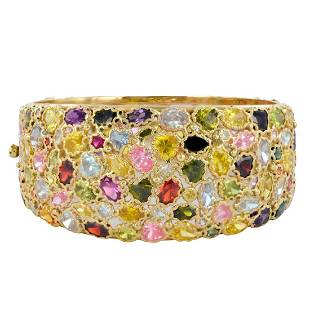 Italian Designer 14K Yellow Gold Multi-Gemstone Bangle: An exceptional quality impressive contemporary bracelet with various gemstones including garnets, sapphires, tourmalines and many others. Finely detailed setting. Marked 14K Italy MI. Weight 54.86 gra