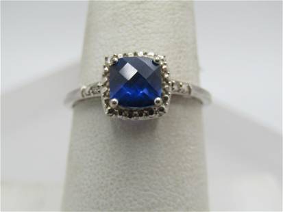 10kt Blue Sapphire Diamond Ring, Sz. 7.5. White Gold: 10kt Blue Sapphire Diamond Ring, Sz. 7.5. White Gold. Honey comb faceted blue sapphire square cushion corner stone with an illusion halow around it and a single diamond at the top of the shoulders of